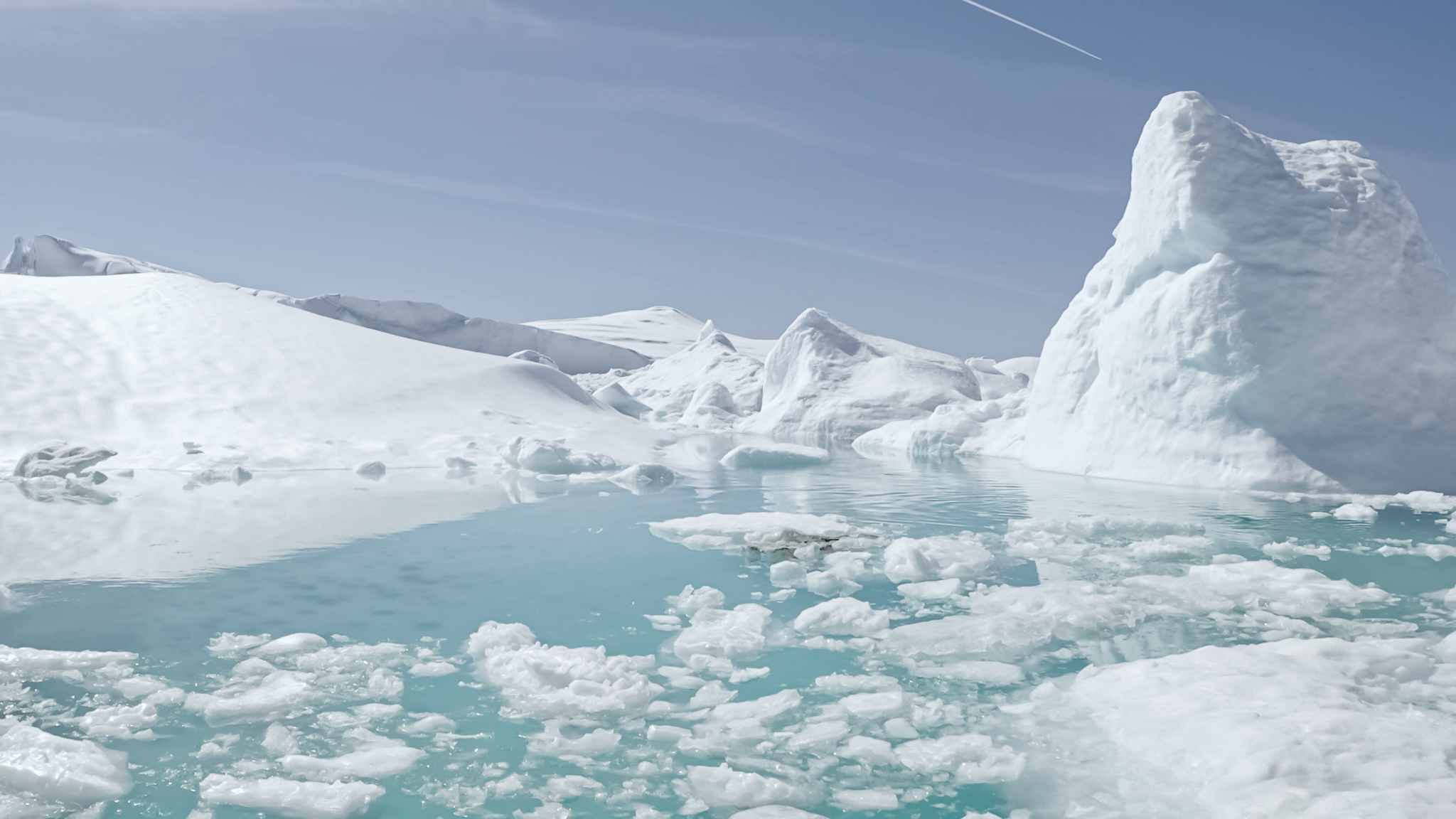 close-up drone shot along polar meltware in ilulissat icefjord, greenland